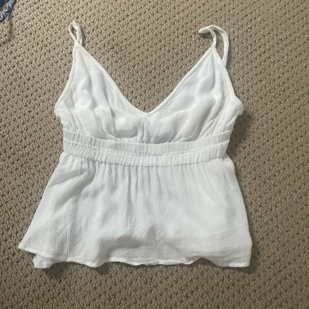 Cute small white top flows at the bottom!